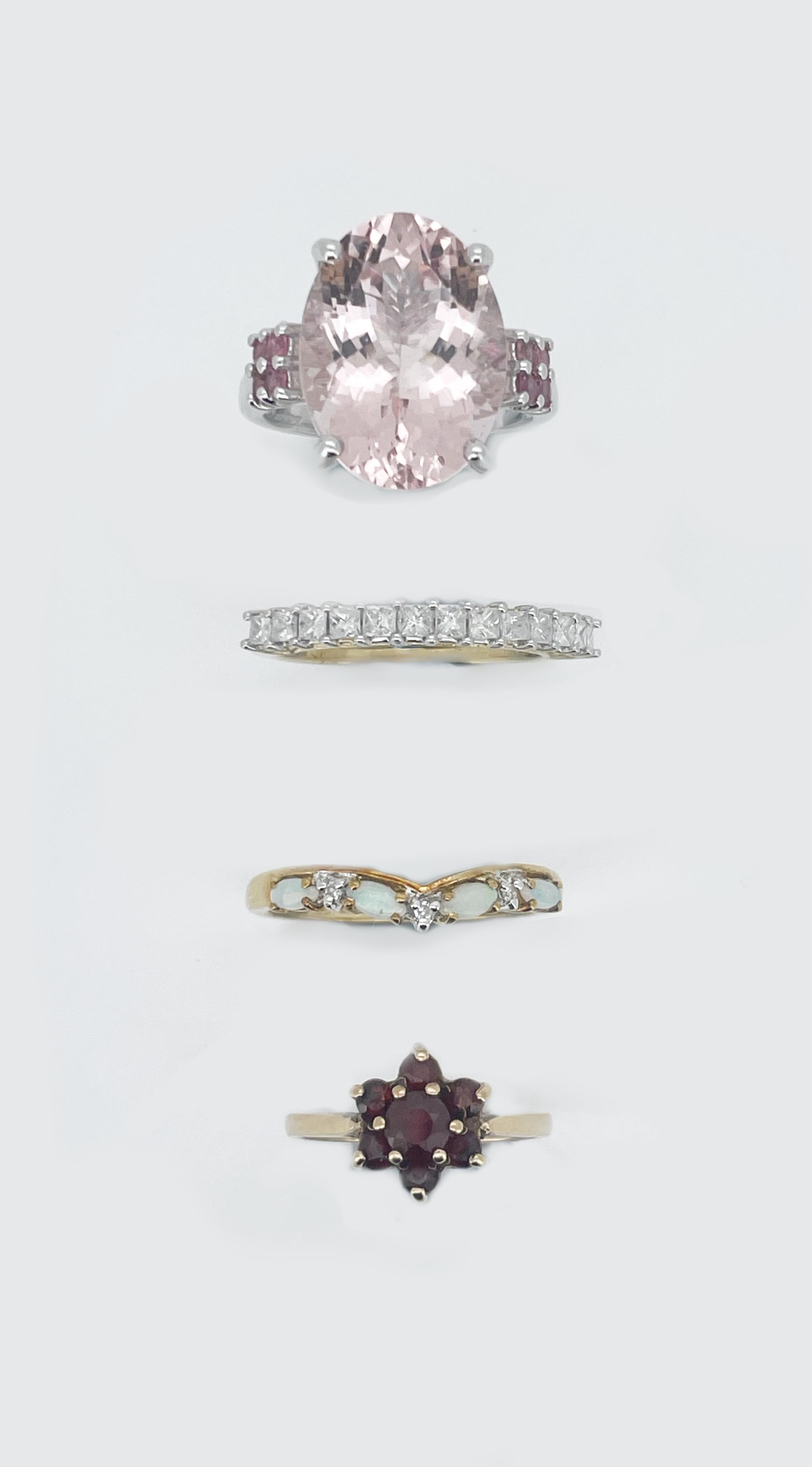 Four assorted modern 9ct and gem set rings, including thirteen stone diamond half hoop, size N/O, garnet cluster, size I, white opal and diamond chip, size O and white gold and morganite ring, size O, gross weight 12 gra
